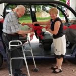 Kensington Park Senior Living resident and director cut the ribbon on the community's new Gem E4 electric passenger vehicle