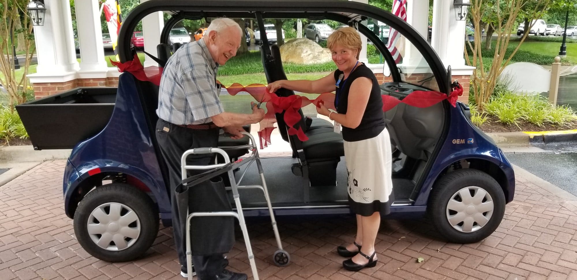 Kensington Park Senior Living resident and director cut the ribbon on the community's new Gem E4 electric passenger vehicle