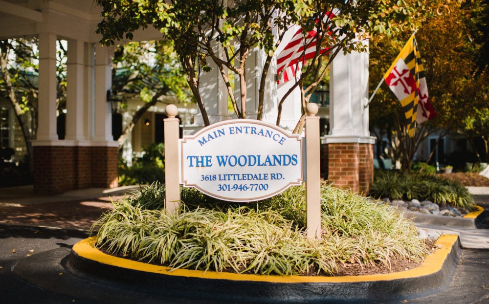 Sign at main entrance for The Woodlands assisted living neighborhood at Kensington Park Senior Living in Maryland