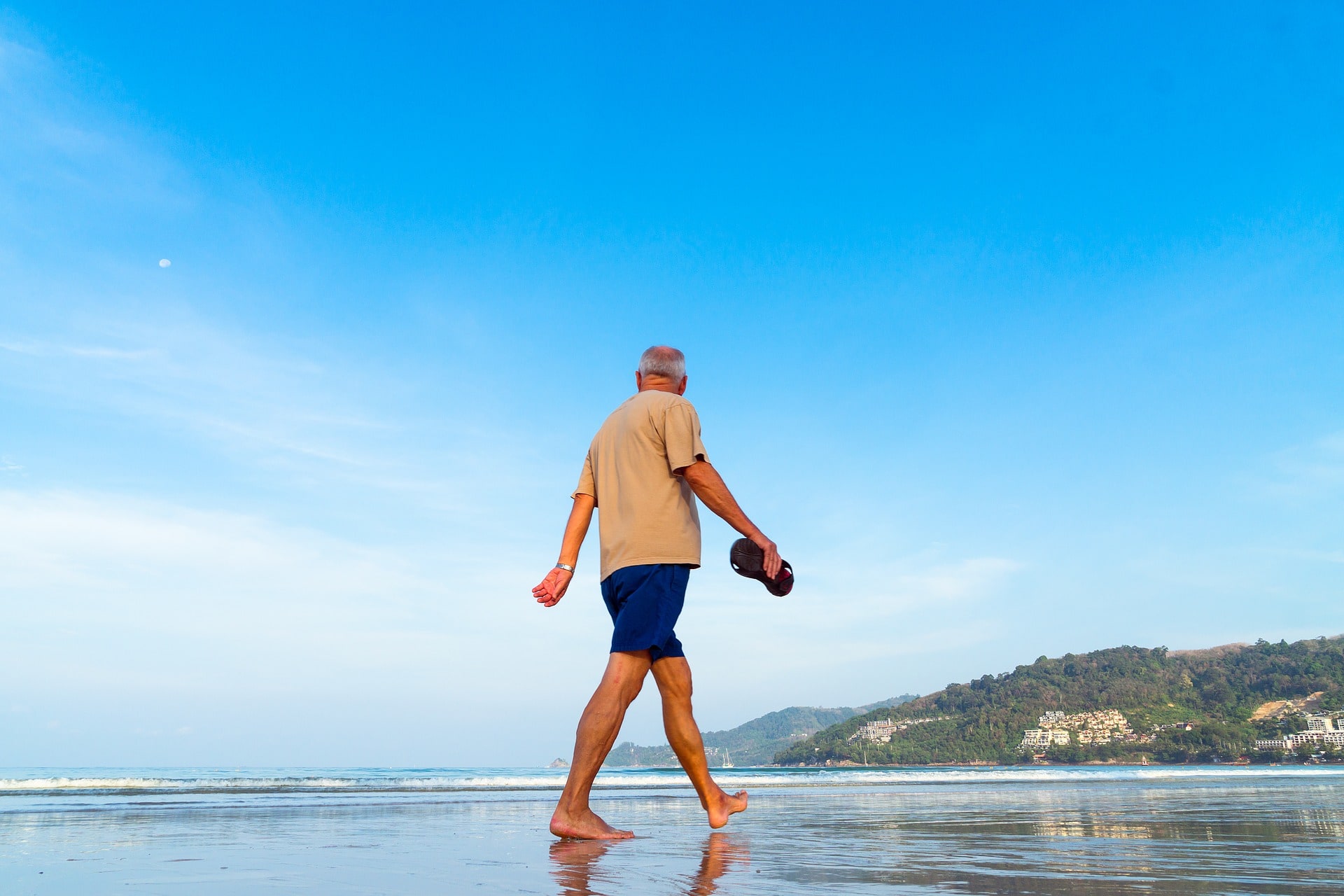Senior Male Walking on Beach