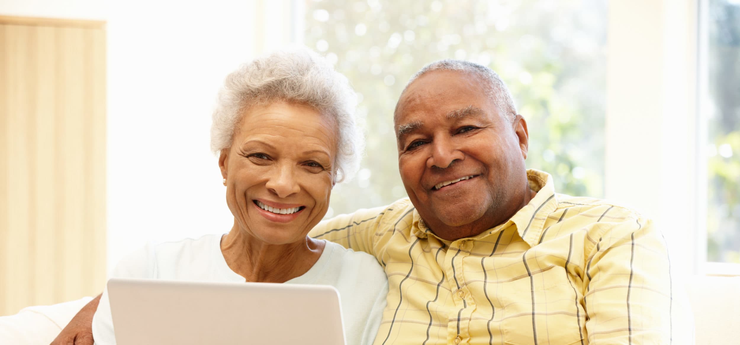 Senior African American couple using laptop stock photo
