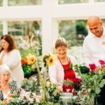 elderly and middle age adult caregivers gardening together