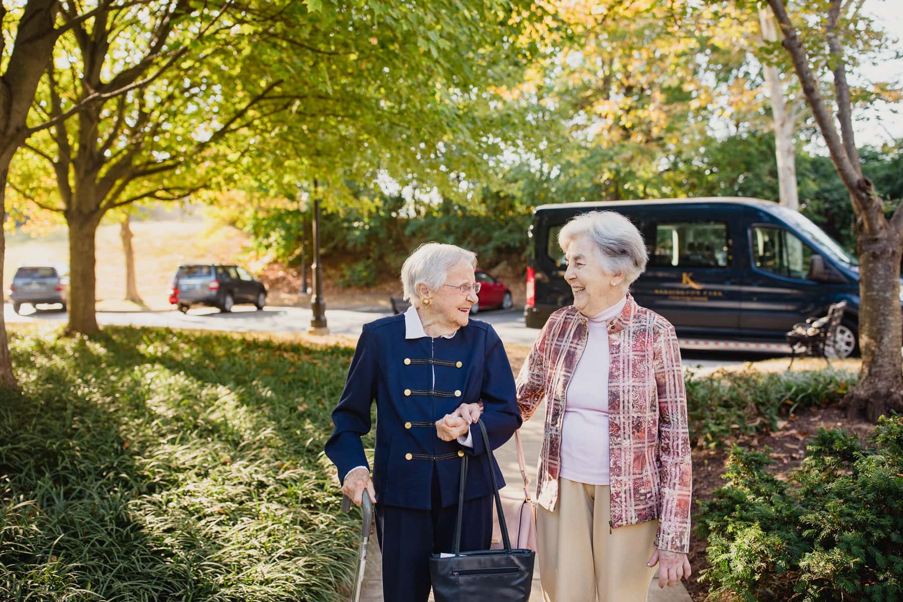 Two older ladies walking down the park