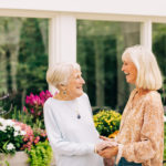 elderly woman and caregiver in garden