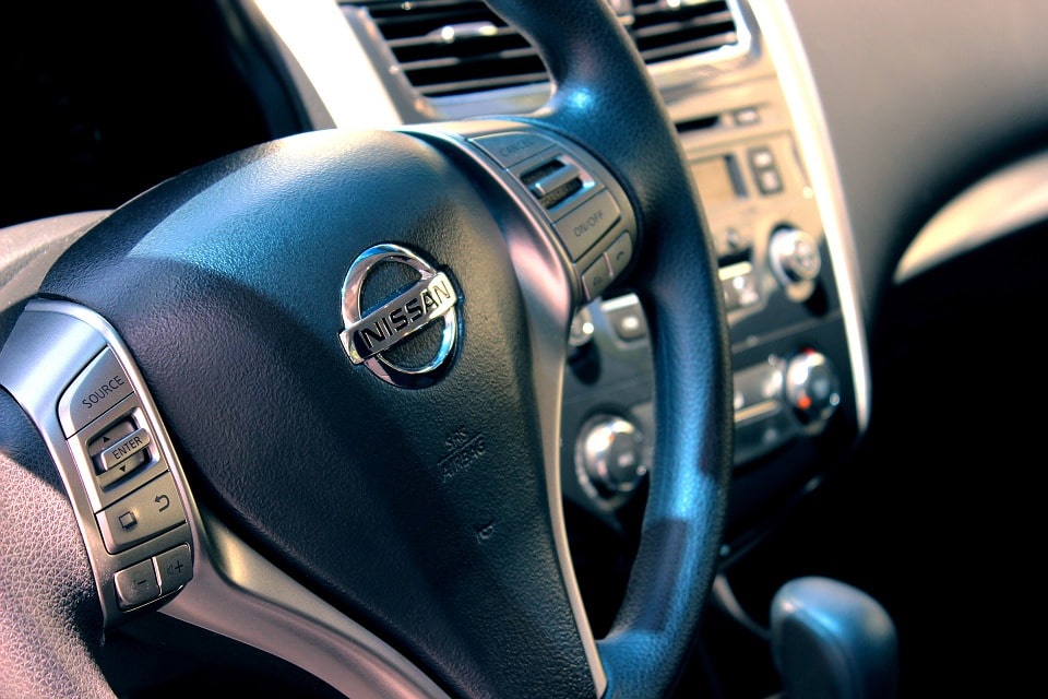 Nissan steering wheel inside car.