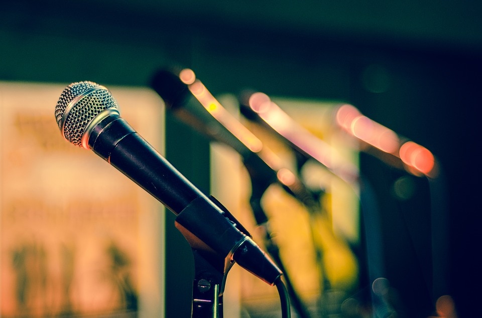 Microphones lined up on stage.