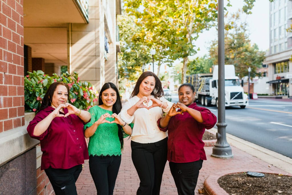 women holding heart signs with their hands