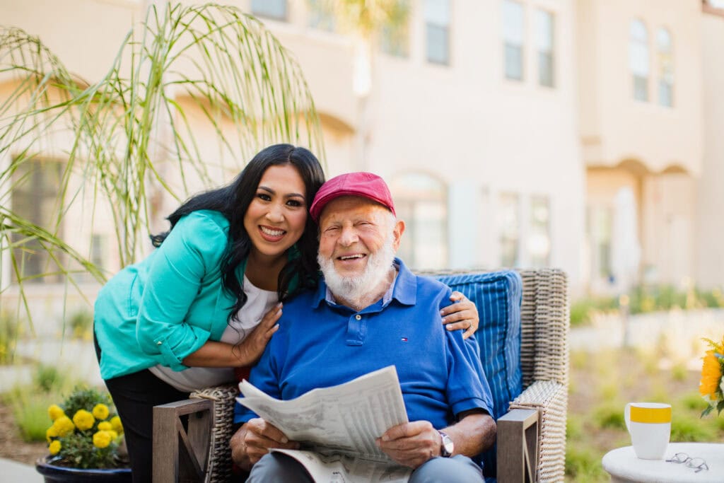woman hugging old man with newspaper