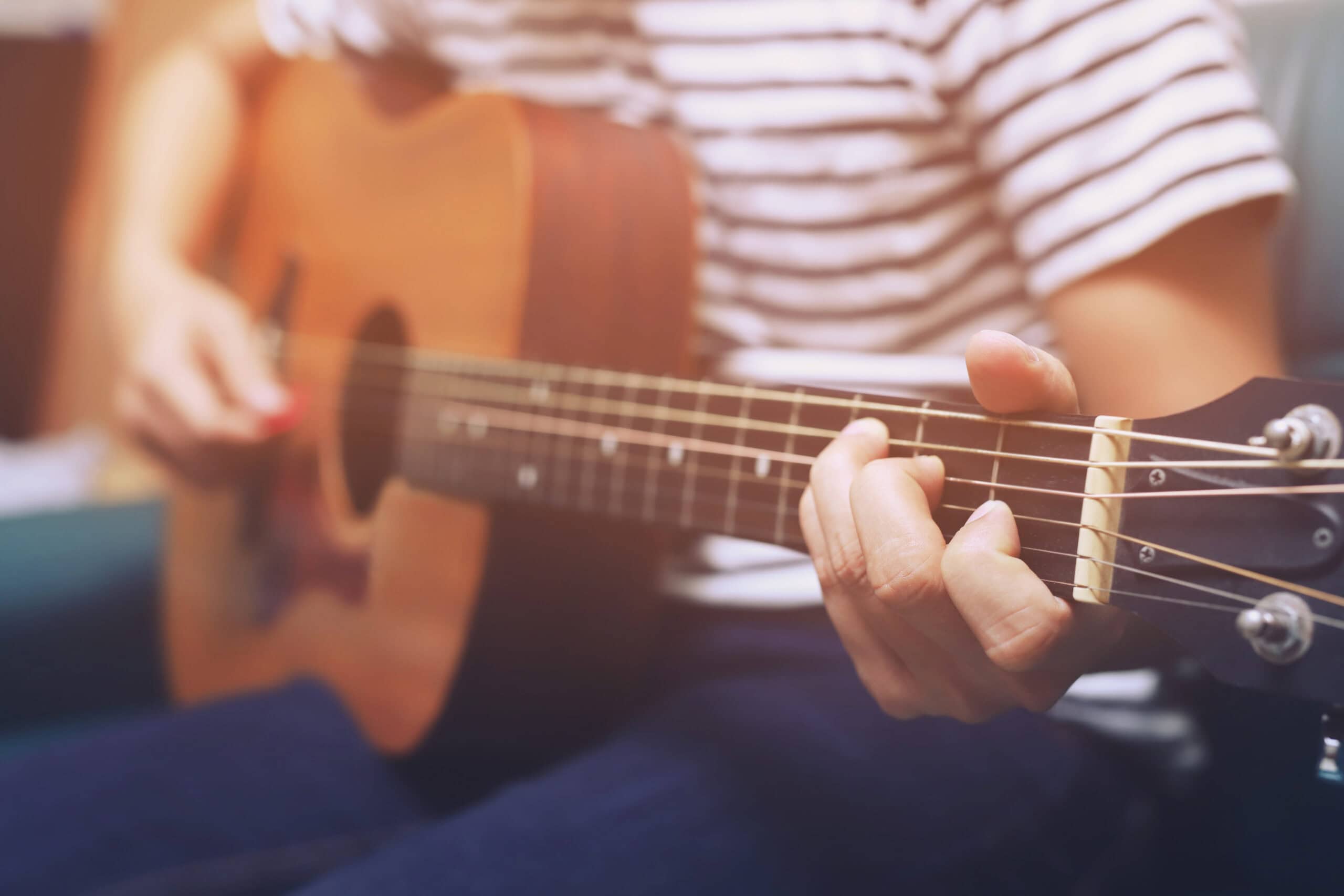Stylish Acoustic Guitar Playing by hand. Artist musician in public park.