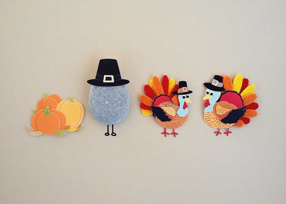 Thanksgiving decorations with pumpkin, pilgrim hat, and two turkeys.
